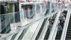  ?? — Reuters ?? Shoppers ride escalators inside a store at a mall in Mumbai, India.