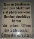  ??  ?? A sign warns: "Put on your gas mask before opening doors!"