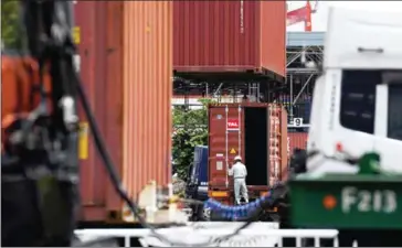  ?? TOSHIFUMI KITAMURA/AFP ?? A worker opens a container at Oi container yard of the Tokyo port in Tokyo yesterday.