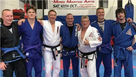  ?? Photo: Sean White ?? BELT GRADING: Celebratin­g after the recent Brazilian jiu jitsu grading at Ka-chi Mixed Martial Arts are (from left) Curtis Evans, Kahn Asgill, professor Vincent Perry, Elijah Kennedy, professor Joe Perry, Steve Prigg and Tim Eaton.