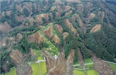  ?? — Reuters ?? Landslides caused by an earthquake are seen in Atsuma town, Hokkaido, northern Japan, in this photo taken by Kyodo on Friday.