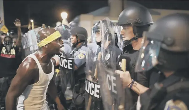  ?? PICTURE: SCOTT OLSON ?? 0 A protester confronts riot police in St Louis during demonstrat­ions against the acquittal of former officer Jason Stockley