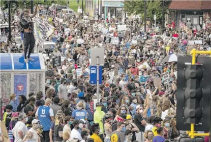  ?? CARLOS GONZALEZ/STAR TRIBUNE VIA AP ?? Protesters gather calling for justice for George Floyd on Tuesday in Minneapoli­s, Minnesota.