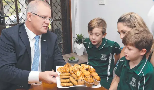  ??  ?? HOME RUN: Prime Minister Scott Morrison chats with Leearna Gibbs and children Taj, 9, and Kai Rotherham, 6, during his visit yesterday. Picture: ANNA ROGERS