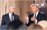  ?? CAROLYN KASTER/ASSOCIATED PRESS ?? President Donald Trump applauds as he stands with Judge Neil Gorsuch in the East Room of the White House on Tuesday.