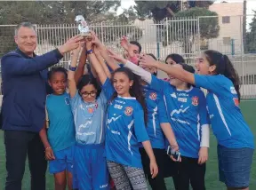  ?? (Courtesy) ?? EREL MARGALIT celebrates with young soccer players in Jerusalem last week.