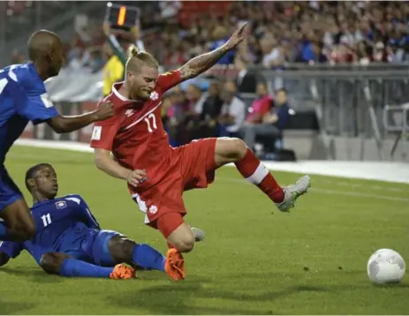  ?? JOE BLACKER/THE CANADIAN PRESS ?? Canadian fullback Marcel De Jong gets tripped up against Belize during World Cup qualifying play Friday night at BMO Field.