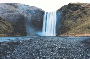  ??  ?? The Skogafoss waterfall near Skogar, Iceland, is one of the country's most popular sites, but the crowds have vanished during the coronaviru­s pandemic.