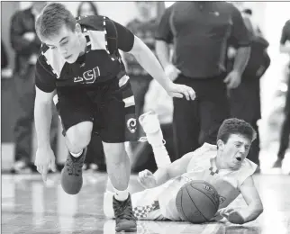  ?? Herald photo by Ian Martens ?? Raymond Comets’ Jeter Heggie slides across the floor behind LCI Rams’ Will Boehme after battling for the ball in the semifinals of the annual Sugar Bowl basketball tournament Wednesday at Raymond High School.