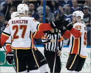  ?? AP PHOTO CHRIS O’MEARA ?? Calgary Flames center Sam Bennett (93) celebrates his goal against the Tampa Bay Lightning with defenseman Dougie Hamilton (27) during the second period of an NHL hockey game Thursday in Tampa, Fla.