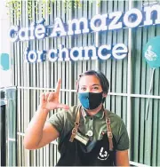  ?? YUTHANA PRAIWAN ?? A barista demonstrat­es the sign language to place an order for a latte at Cafe Amazon for Chance’s ninth branch, which officially opened yesterday at the SEC.