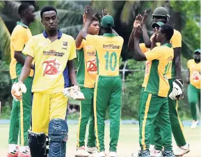  ?? PHOTO BY KAVARLY ARNOLD ?? Vere Technical High School celebrates the wicket of Odane Thompson (foreground) of St Elizabeth Technical High School (STETHS) in their clash in the ISSA-Grace Twenty20 Competitio­n at the STETHS Sports Complex yesterday. Vere won by 18 runs.