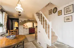  ??  ?? Clockwise from above: The countrysty­le kitchen/dining room; windowsill detail; owners Richard and Janet Fearn at the Nine Stones landmark; one of the two bedrooms; the decked terrace; the reception room, and views of Mount Leinster with the house at...