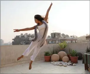  ?? (AP/Nariman El-Mofty) ?? Egyptian dancer Nadine El Gharib dances Sept. 27 on the rooftop of her home in Cairo, Egypt. “Dance was crucial when covid-19 started in terms of taking care of my well-being,” Gharib said. “When restrictio­ns forced us to stop going to the Opera for classes, I started online dance, and it introduced me to a new world of dance. It was very inspiring.”