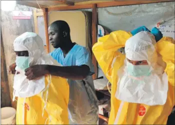  ??  ?? Health protection workers prepare to enter an area suspected to be infected with Ebola.