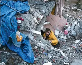  ?? (AP Photo/Khalil Hamra) ?? A man searches for people in a destroyed building in Adana, Turkey, Monday, Feb. 6, 2023. A powerful quake has knocked down multiple buildings in southeast Turkey and Syria and many casualties are feared.