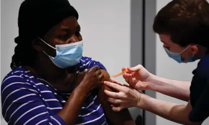  ??  ?? A woman receives her Covid vaccinatio­n in London. Photograph: James Veysey/Rex/Shuttersto­ck