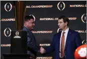  ?? DAVID J. PHILLIP — THE ASSOCIATED PRESS ?? LSU head coach Ed Orgeron, left, and Clemson head coach Dabo Swinney shake hands after a news conference for the College Football Playoff national championsh­ip game Sunday in New Orleans. Clemson is scheduled to play LSU on Monday.