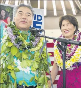  ?? Eugene Tanner
Associated Press ?? DAVID IGE, with wife Dawn, trounced Abercrombi­e despite being outspent by a 10-1 margin. He will face a Republican and independen­t in November’s election.