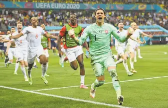  ?? Justin Setterfiel­d / Getty Images ?? Switzerlan­d goalkeeper Yann Sommer celebrates after saving the decisive penalty taken by Kylian Mbappe of France during a Euro 2020 roundof16 match in Bucharest, Romania.