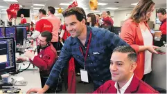  ??  ?? CIBC Ambassador Scott McGillivra­y makes a telephone trade with a client, with help from a CIBC trader. Every year on Miracle Day, CIBC traders donate their fees and commission­s for children’s charities. Supplied
