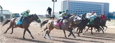  ?? The Sentinel-Record/Richard Rasmussen ?? Horses and their jockeys break from the gate during the first race of the 2021 live race meeting at Oaklawn Racing Casino Resort on Friday.