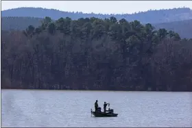  ?? (Arkansas Democrat-Gazette/Staton Breidentha­l) ?? A fisherman shows off his catch March 4 on Lake Maumelle in Pulaski County.