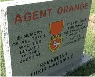  ?? LEFT: The James L. Whitby chapter of Disabled American Veterans dedicated a new Agent Orange Memorial at Crestview Cemetery in August. Standing with the monument are, from left, Commander Benny Arego, Treasurer James Sanders and Adjutant and Service Offic ?? ABOVE:The new Agent Orange Memorial at Crestview Cemetery is to honor those who died or suffered illness due to exposure to the chemical herbicide and defoliant while in Vietnam. (Courtney Edwards/Hot Springs Sentinel-Record)