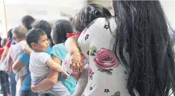  ??  ?? NEVER-ENDING JOURNEY: Migrant women and their children, after their release by immigratio­n officials in Texas.