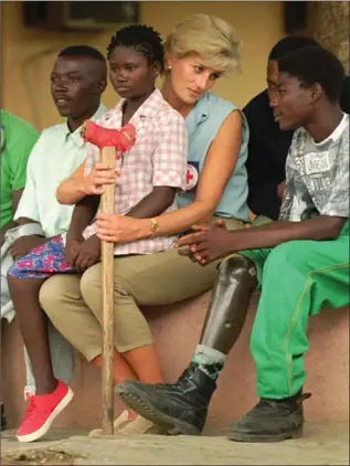  ??  ?? In January 1997, Diana, Princess of Wales, visited children who had lost limbs due to landmines.