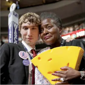  ?? AP/JOHN LOCHER ?? Wisconsin delegates Matthew LaRonge and Thelma Sias embrace Thursday during the invocation on the final day of the Democratic National Convention in Philadelph­ia.