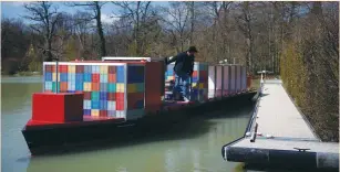  ?? (Stephane Mahe/Reuters) ?? A PILOT STEERS a scaled-down model of an ULCS container ship on a lake at the Port Revel Shiphandli­ng Training Center in Saint-Pierre-de-Bressieux, France this week.