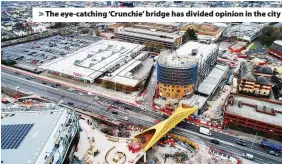  ??  ?? > The eye-catching ‘Crunchie’ bridge has divided opinion in the city