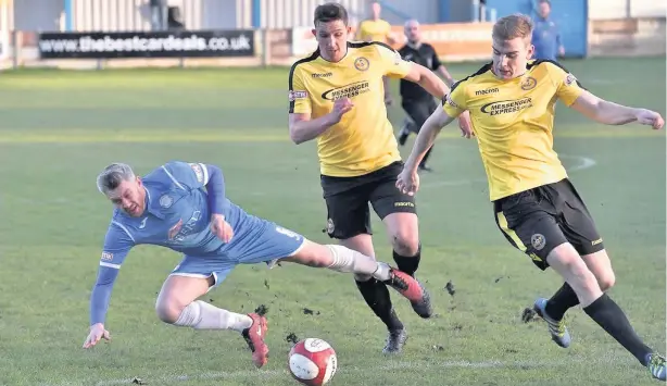  ?? Frank Crook ?? Lee Gaskell goes down under a challenge during Ramsbottom’s game against Skelmersda­le at the weekend