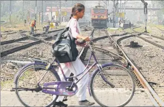  ?? PARDEEP PANDIT/HT ?? TIME TO PONDER: Barely a week after the Amritsar rail tragedy, a school girl is unmindful of the approachin­g train as she crosses the tracks in Jalandhar on Thursday.