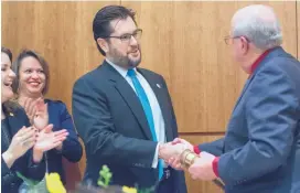  ??  ?? Newly elected Speaker of the House Brian Egolf, D-Santa Fe, is presented the gavel by former Speaker of the House Don Tripp, R-Socorro, at the start of the Legislativ­e session at the state Capitol in Santa Fe on Tuesday.