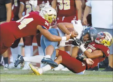  ?? Luis Sinco Los Angeles Times ?? BISHOP ALEMANY defenders Jaime Malungahu, left, and Jshawn Frausto Ramos tackle Kadius Fuimaono.