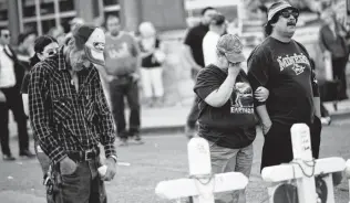  ?? Marie D. De Jesús / Staff photograph­er ?? Mourners visit the makeshift memorial in honor of the victims of the El Paso shooting that left 22 people dead. Mayor Ron Nirenberg and City Council have called for a special legislativ­e session to address gun safety.