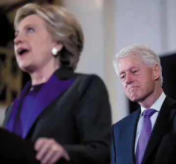  ??  ?? TIRED AND EMOTIONAL: Former US president Bill Clinton is close to tears as he listens while Hillary addresses campaign staff after conceding defeat. Photo: Andrew Harnik/AP