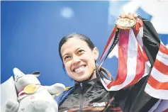  ?? — AFP photo ?? Malaysia’s Nicol Ann David holds up her gold medal during the awards ceremony for the women’s singles squash event at the 2018 Asian Games in Jakarta.