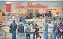  ?? BILL KEAY/PNG ?? Tim Hortons found itself under attack Thursday after the chain pulled ads by pipeline giant Enbridge from its in-store screens.