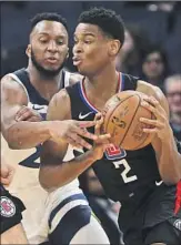  ??  ?? CLIPPERS ROOKIE Shai Gilgeous-Alexander tries to drive past defender Josh Okogie.