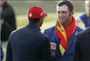  ?? ALASTAIR GRANT — THE ASSOCIATED PRESS FILE ?? In this file photo, Europe’s Jon Rahm, right, is congratula­ted by Tiger Woods during the trophy ceremony after the European team won the 2018 Ryder Cup golf tournament at Le Golf National in Saint Quentin-enYvelines, outside Paris, France. Rahm calls Woods his alltime hero and says this was the best moment of his career.
