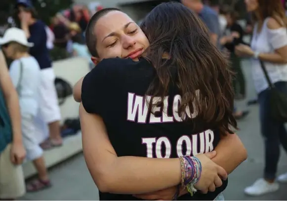  ?? JOE RAEDLE/GETTY IMAGES ?? This has actually been an inspiring and hopeful seven days because of actions by students like Emma Gonzales, left, being hugged following the Florida shooting, Tony Burman writes.