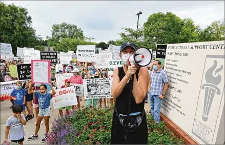  ?? HYOSUB SHIN / HYOSUB.SHIN@AJC.COM ?? Melanie Caceres (foreground) leads a rally Friday in Suwanee against Gwinnett County Public Schools’ decision to make all fall instructio­n online only. Many parents fear online learning will hurt their children’s education and their families’ well-being.