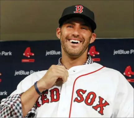  ?? ASSOCIATED PRESS ?? Boston Red Sox baseball player J.D. Martinez smiles as he buttons up his jersey during an introducto­ry news conference, Monday in Fort Myers, Fla.