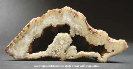  ??  ?? An amygdale exhibiting several calcite crystals cut in cross section.