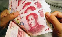  ?? GREG BAKER / AP 2003 ?? Chinese 100 Yuan notes feature a portrait of Mao Zedong. The U.S. backed off listing China as a currency manipulato­r.