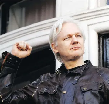  ?? FRANK AUGSTEIN / THE ASSOCIATED PRESS ?? Julian Assange greets supporters outside the Ecuadorean embassy in London on Friday, following news that Swedish prosecutor­s are dropping an investigat­ion into a rape claim against the WikiLeaks founder after almost seven years.