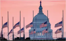  ?? AP Photo/J. David Ake, File ?? ■ Flags flying a half-staff in honor of Sen. John McCain, R-Ariz., frame the U.S. Capitol at daybreak Aug. 26 in Washington. Singer Aretha Franklin and McCain lived through the decade that reshaped so much of American life but were propelled into the 1970s and all the way to 2018, carrying some of the fundamenta­l storylines of the 1960s as they hurtled forward.